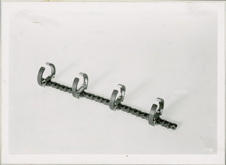 This section of chain with four clamps is part of a piece of equipment.