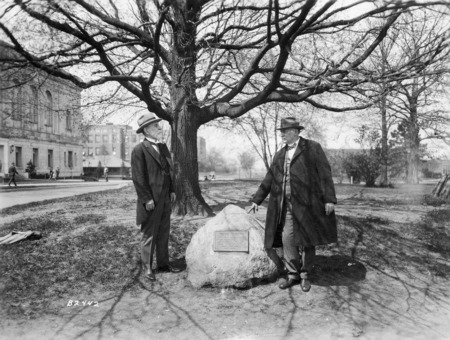 Dr. Pammel (right) and Dr. William Temple Hornaday (left), are standing around a stone tablet commemorating Dr. Hornaday's contributions as a zoologist and conservationist. Part of the inscription reads, "It was on this campus as a student, June 1873, that ...'I Found myself...'".