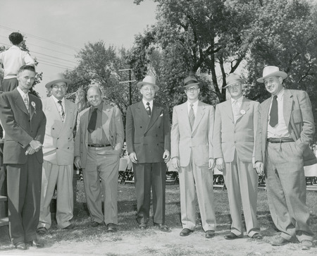 Seven 25-year lettermen are posing at the 1951 Homecoming.