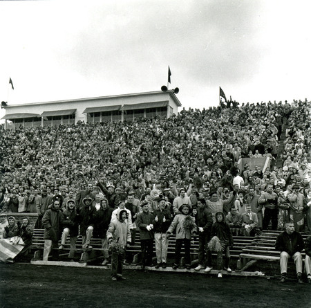 The crowd stands and cheers at the Iowa State vs. Kansas State Homecoming Game at Clyde Williams Field.