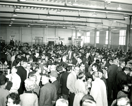 Alumni gather in the State Gym for a coffee reception after the Homecoming game, 1969.