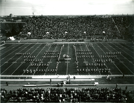 The ISU Marching Band appears in "I" formation on the football field at Homecoming, October 19, 1974.