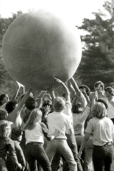 Many hands lift the push-ball above the crowd in a game on Central Campus as part of Homecoming, 1978.