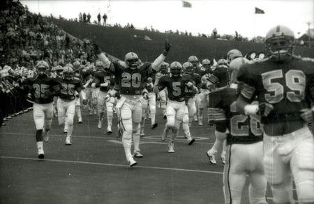 The ISU football team enters the football field for the Homecoming game against Kansas, 1985.