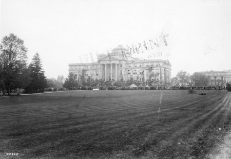 A view of Beardshear across the lawn. Onlookers gather to participate in VEISHEA activities.