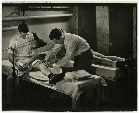 Beryl Taylor is working on wrestler Joe Laucks's left knee.