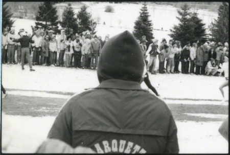 Several runners at the NCAA Women's cross-country meet Milwaukee, Wisconsin, on November 25, 1985, several hours before the plane crash. Spectator obstructs view.