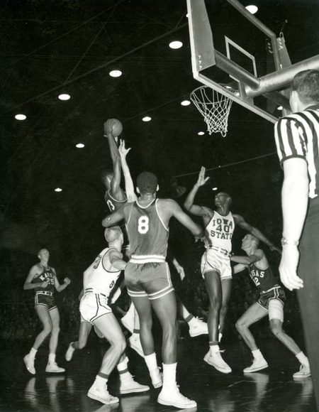 Wilt Chamberlain (Kansas #13) tries to make a basket.