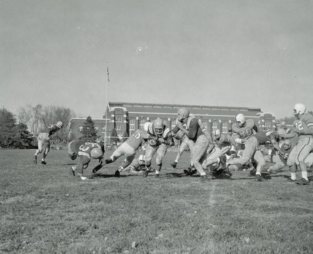 Iowa State vs. Drake football game in progress with State Gymnasium in the background.