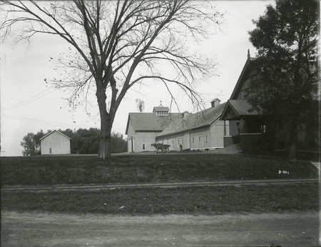 To the left of the Horse Barn is shown a teamster driving a draft team past the Old Cattle Barn.