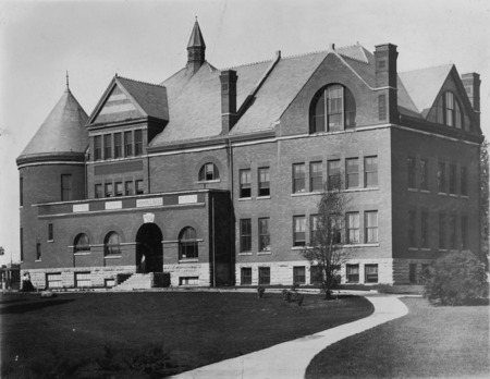 A sidewalk leads up to the front steps of Morrill Hall.