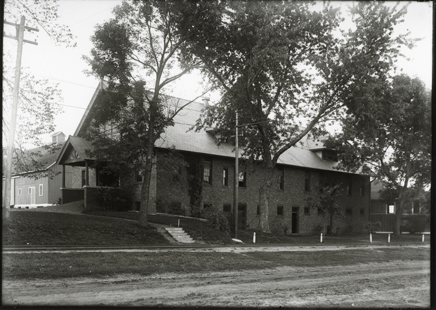 Photograph of the Landscape Architecture building (Horse Barn), with the Cattle Barn in the background and the Theater Workshop on the right. The view is looking northeast.