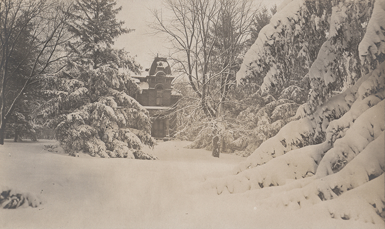 Photograph of South Hall on the Iowa State campus in winter, showing the west elevation. The view is looking east. The image depicts the building partially obscured by snow-covered trees and deep snow on the ground. Annotation: "South Hall."