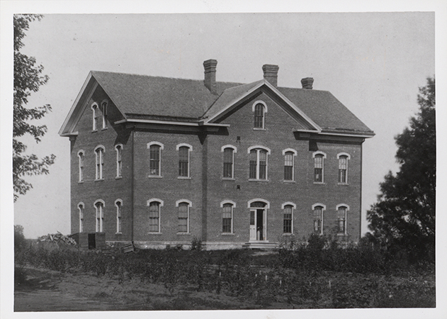 Photograph of North Hall on the Iowa State campus, showing the south and west elevations. The image depicts a three-story brick building with arched windows and a central entrance. Annotation: "Fig. 11 North Hall."