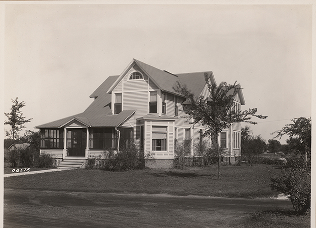 Photograph of Coburn House taken from across a road. The front porch has been screened in.
