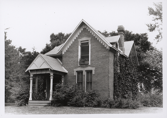 Photograph of Osborn Cottage looking north-west at the front and east side of the building. There is ivy growing on the east wall of the building.