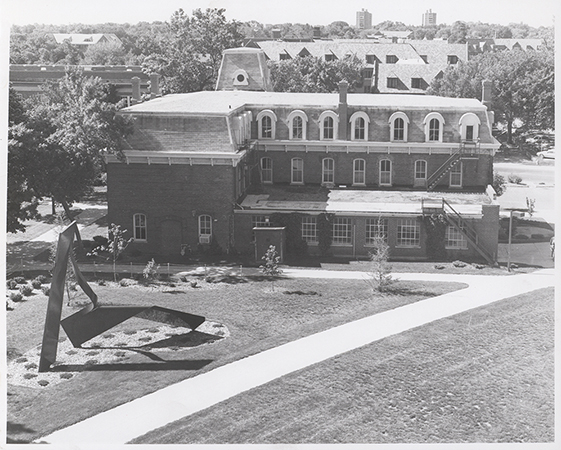 Photograph of the north side of the Laboratory of Mechanics looking down from Black Engineering with the Student Services Building and Friley Hall visible behind (at the top). Annotation: ''Lab of Mechanics Bldg 6/89 from top of Black Engineering.''