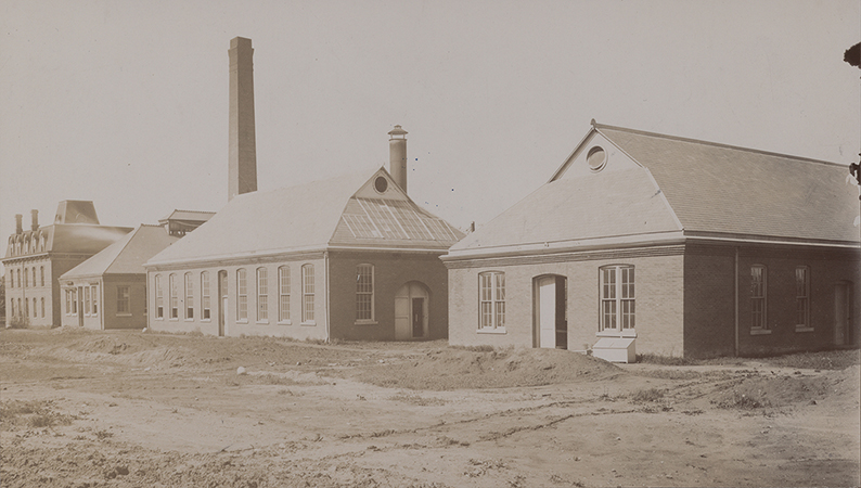 Photograph of the engineering laboratories. From left to right (south to north) these buildings are the Laboratory of Mechanics, the Power Station, Building A, and the Aerospace Laboratory. Annotation: ''L to r; Old Eng Hall now T & A M; Power Station; Forge Shop & Foundry; Pattern Shop.''