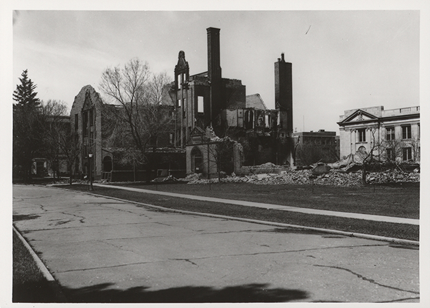 Photograph showing the southeast portion of Margaret Hall after it was destroyed by fire on April 9, 1938. MacKay Hall can be seen to the north (right).