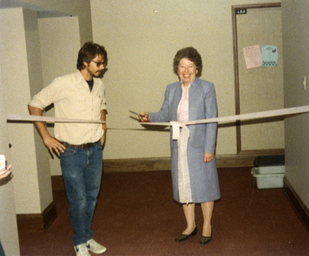 LSA President Mark Anderson and Margaret Mae Gross participate in the ribbon cutting for new staff lounge, Margaret Mae Gross is holding a pair of scissors.