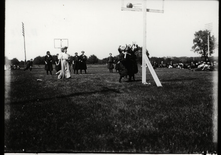 Black and white photograph of women playing a basketball game at Iowa State College in 1908.