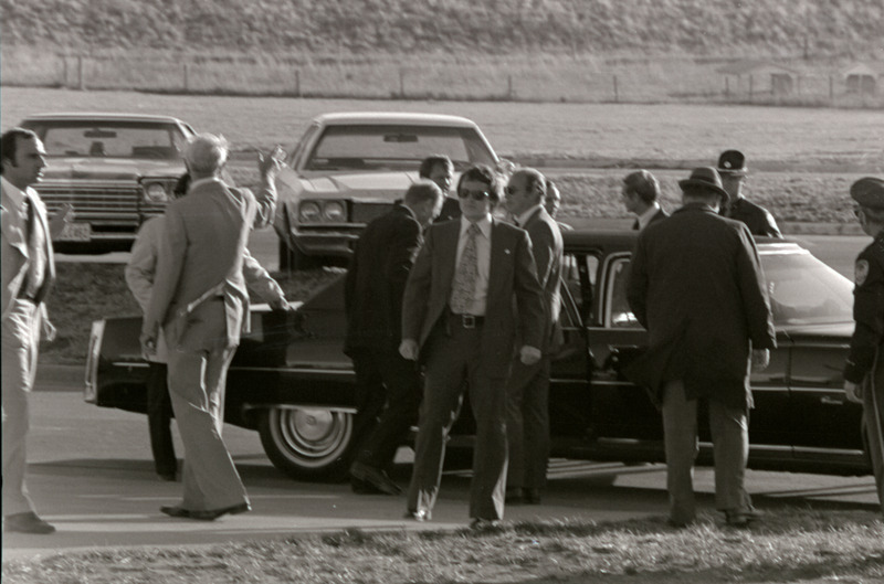 Photograph of the presidential motorcade and Gerald Ford's tour of the Iowa State University College of Veterinary Medicine building