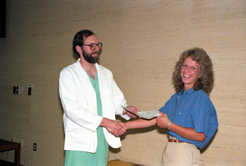 Photograph of Martha Buttrick receiving her residency certificate from Dean Riedesel