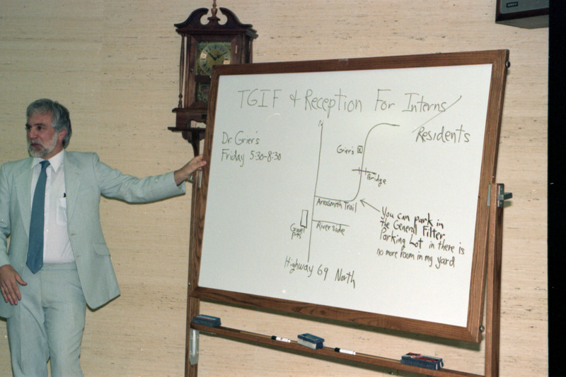 Photograph of Ron Grier providing directions to a reception for residents and interns
