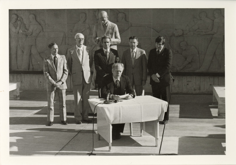 Photograph of President Gerald Ford speaking after he signed into law the Emergency Livestock Credit Act Extension during a visit to the Iowa State University College of Veterinary Medicine building