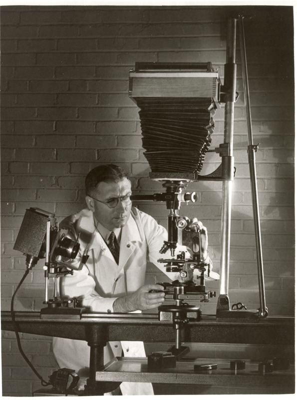 Photograph of Harry Biester of the ISC Veterinary Medical Research Institute preparing to take a photograph in 1936