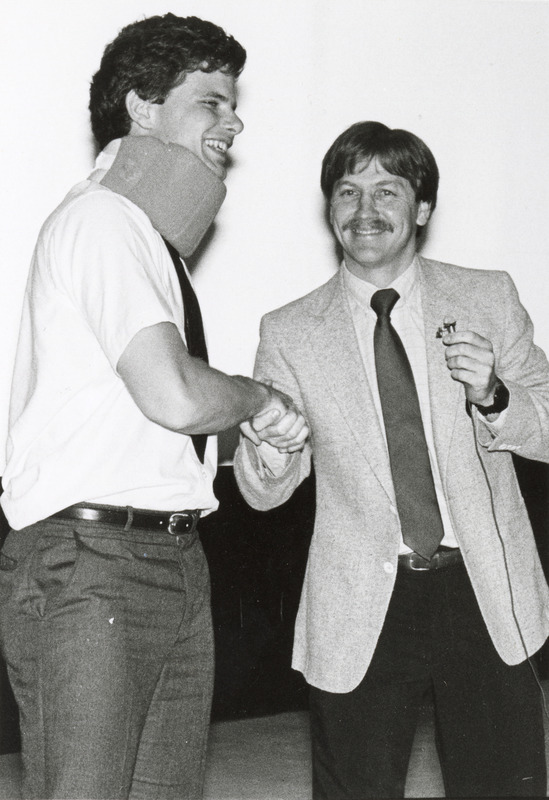 Photograph of James Noxon presenting at a college awards ceremony