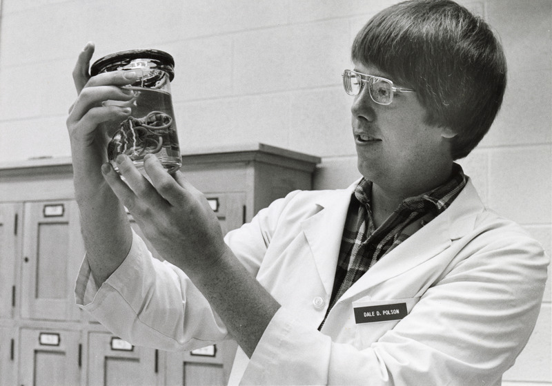 Photograph of veterinary student Dale Polson examining a specimen in the pathology laboratory