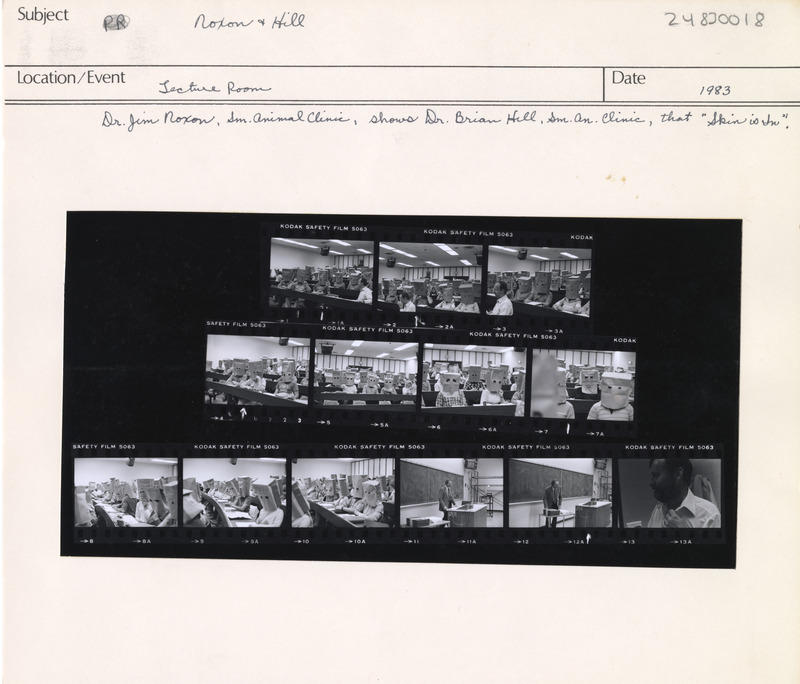 Annotation: "Noxon & Hill. Lecture Room. Dr. Jim Noxon, Sm. Animal Clinic, shows Dr. Brian Hill, Sm. An. Clinic, that 'Skin is in.'"