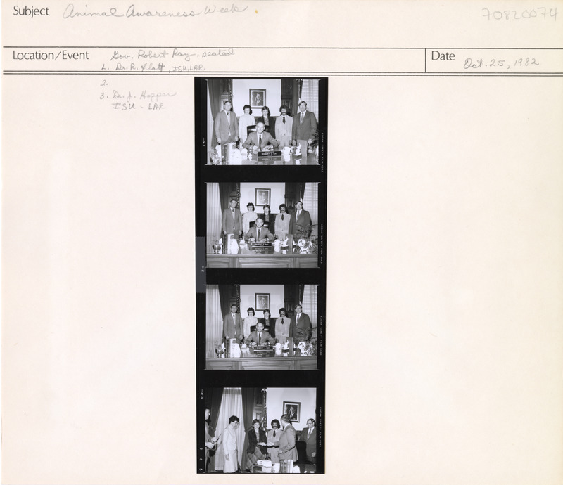 Annotation: "Animal Awareness Week. Gov. Robert Ray, seated. L. Dr. R. Flatt, ISU, LAR. 2. 3. Dr. J. Hopper, ISU-LAR"