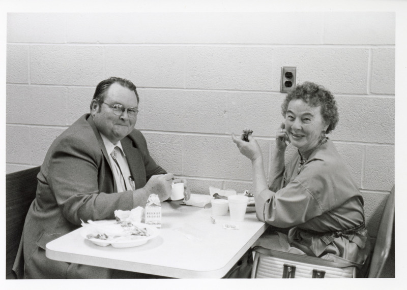 Photograph of William Switzer eating with an unknown person