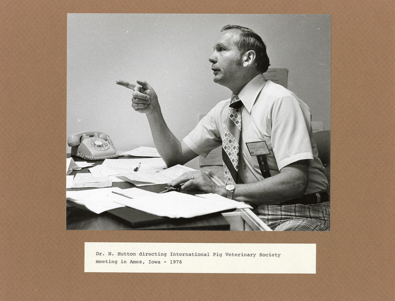 Annotation: "Dr. N. Hutton directing International Pig Veterinary Society meeting in Ames, Iowa - 1976"
