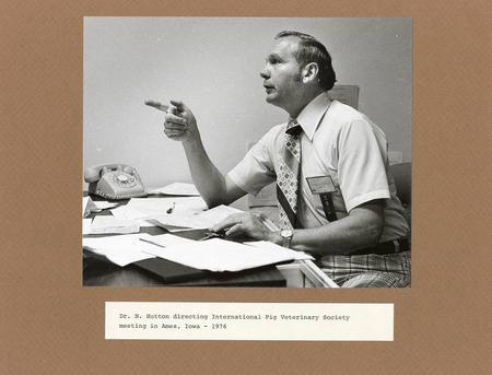 Annotation: "Dr. N. Hutton directing International Pig Veterinary Society meeting in Ames, Iowa - 1976"