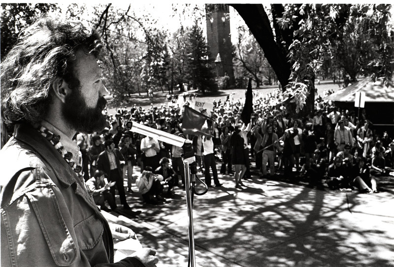 A photograph of students protesting the Kent State shooting on campus, with the Campanile visible in the background.