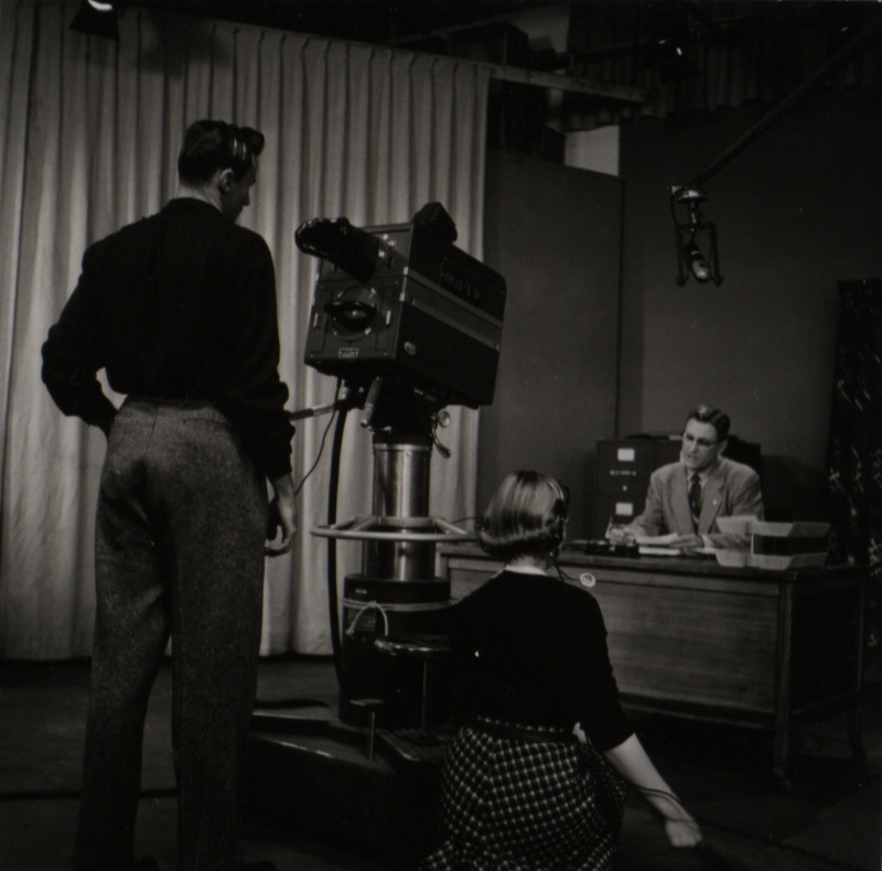 Photograph of a camera crew filming Dave Bateman on the set of WOI-TV.