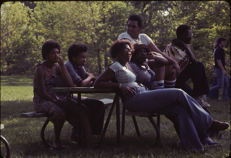 Photograph showing students watching a baseball game organized by the Multicultural Student Affairs Office.
