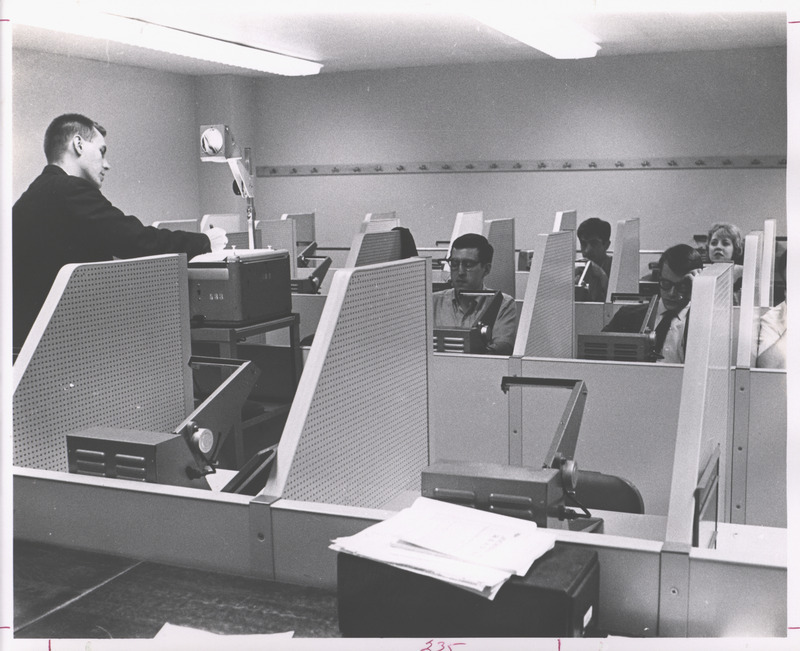 A photograph showing a "help class" with students working in the reading lab.