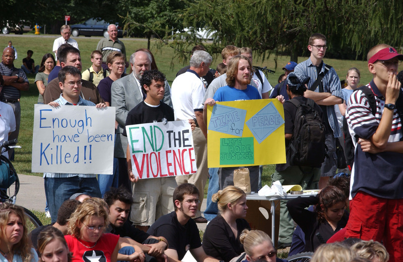 Students display posters at the September 11th remembrance program held on central campus in front of Curtiss Hall.