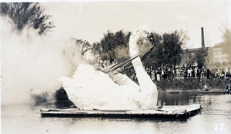 Photograph showing the end of the 1935 VEISHEA water carnival. Iowa State's first swans, named Lancelot and Elaine, were introduced from this swan-shaped float.