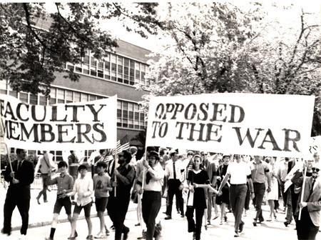 A photograph showing Iowa State University faculty members and their families at the start of the "March of Concern," a VEISHEA parade antiwar demonstration.