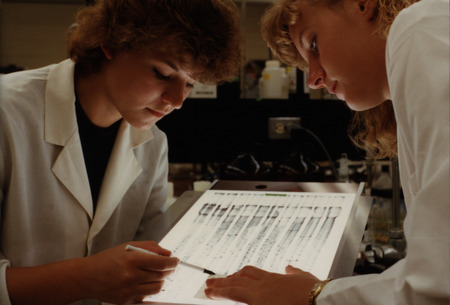 Two students reviewing research data in an Iowa State University laboratory.