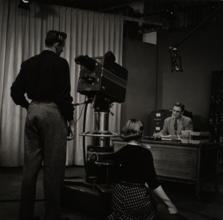 Photograph of a camera crew filming Dave Bateman on the set of WOI-TV.