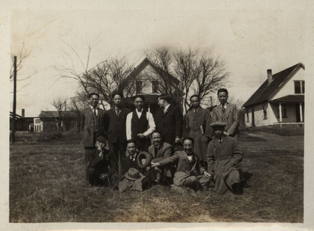 Photograph of a group of Iowa State students from China standing near homes in residential Ames.