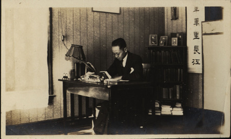 Photograph of a student studying at their desk.