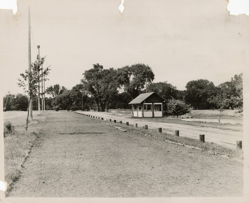 Photograph of a shelter house and a section of cinder track that encircles the ball field in Washington Park