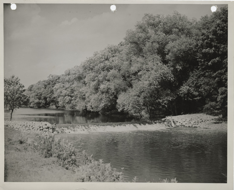 Photograph of the rock and log crib dam on the Winnebago River in Winnebago county